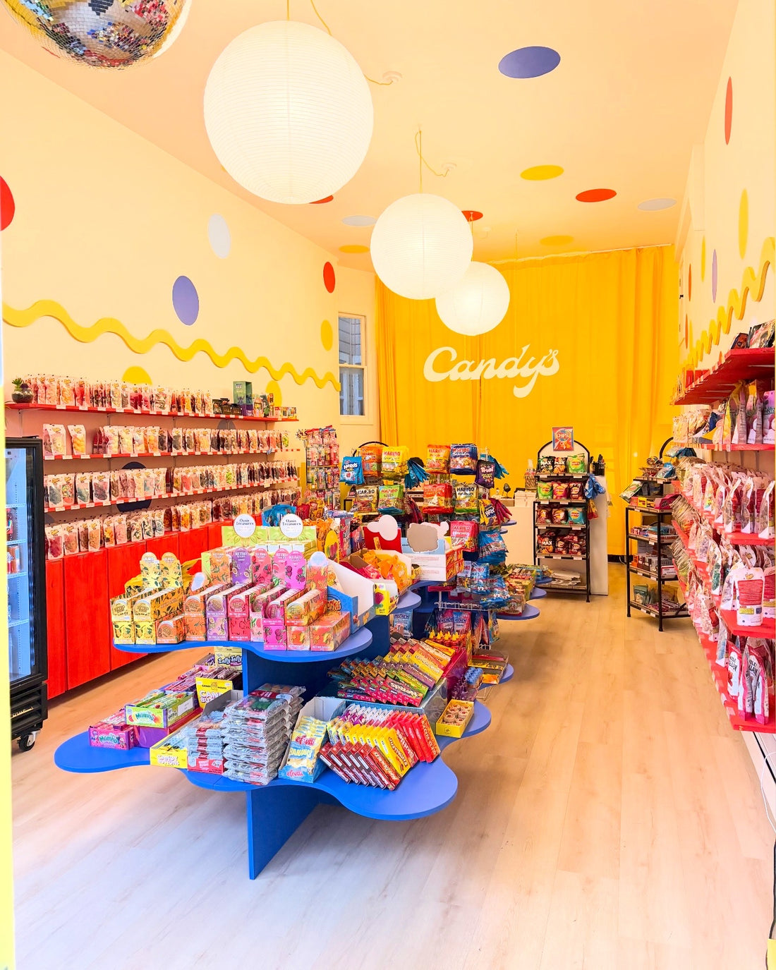 Inside the renovated Candy's shop, with yellow walls, polka dots and candy displays