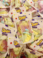 A pile of Candy's Haight Street pouches filled with BUBS sour skulls, diamonds and ovals