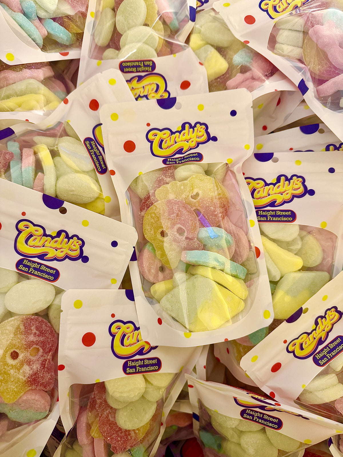 A pile of Candy's Haight Street pouches filled with BUBS sour skulls, diamonds and ovals